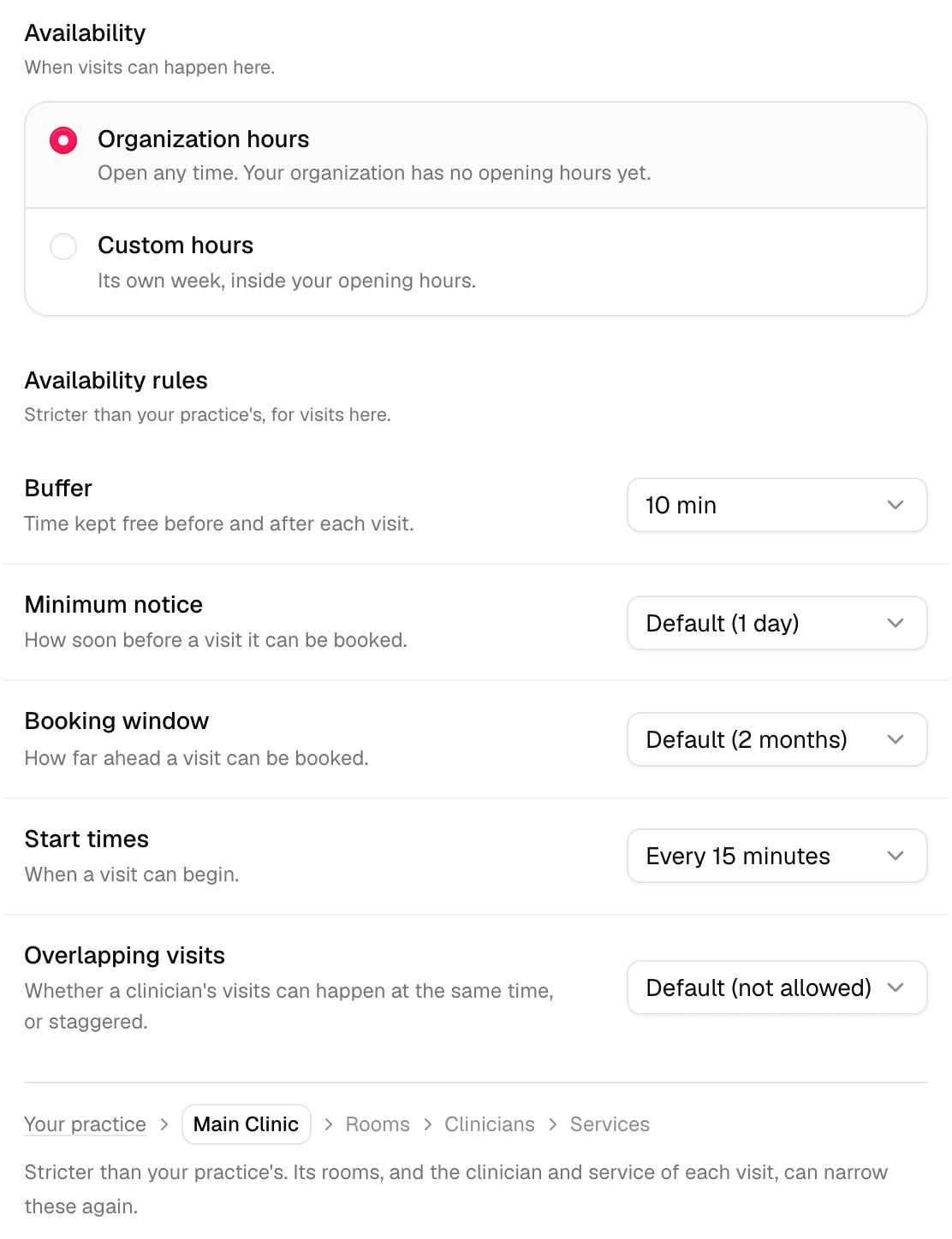 The Main Clinic location sheet: Availability set to Organization hours, then Availability rules with Buffer 10 min, Minimum notice Default (1 day), Booking window Default (2 months), Start times Every 15 minutes and Overlapping visits Default (not allowed), and the chain with Main Clinic highlighted.